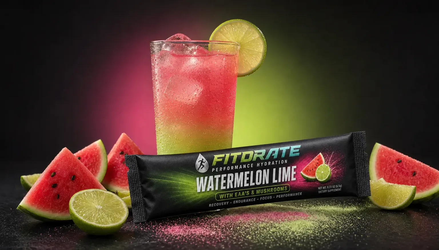 FitDrate™ Watermelon Lime mixed in a glass over ice with watermelon and lime wedges, next to its stick pack
